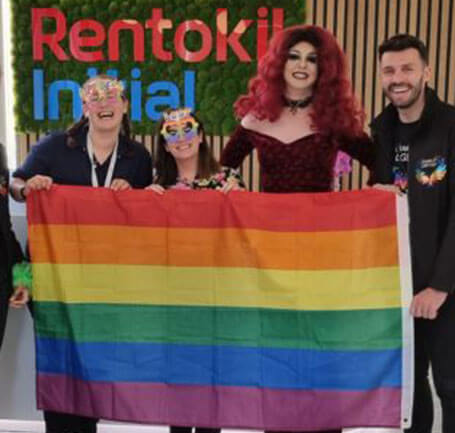 RI colleagues with a gay pride flag  in our headquarters