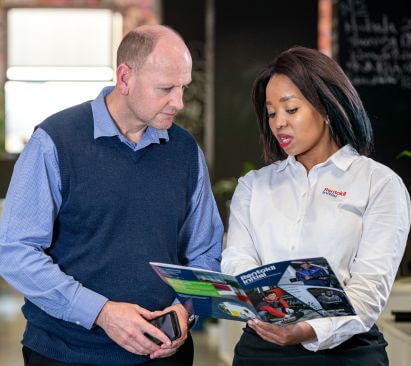 Rentokil Initial saleswoman explaining brochure to customer