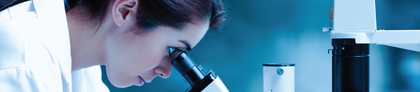 Scientist looking through a microscope