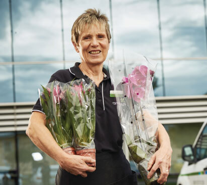 Ambius technician holding orchids