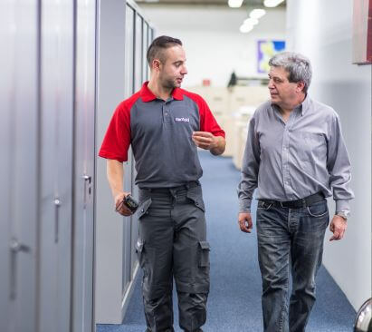 Technician speaking to a customer in an office