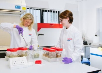 Rentokil Initial scientists taking samples from a jar