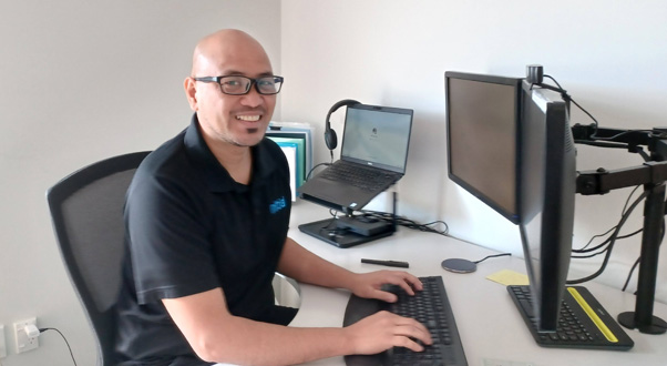 Employee sitting at desk and typing on a computer