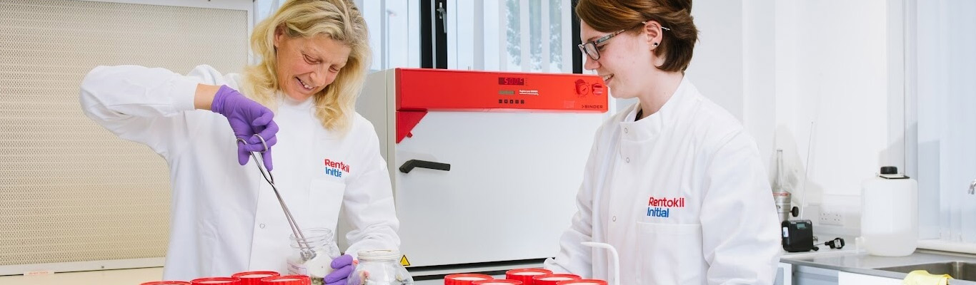 Rentokil Initial scientists taking samples from jar