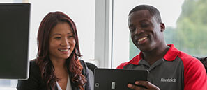 Rentokil technician showing information on a tablet to a customer