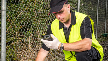 Pest technician checking his handheld device