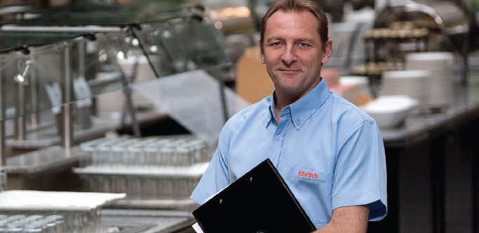 Rentokil technician in a kitchen