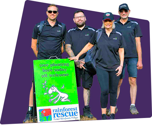 Ambius colleagues in front of rainforest rescue sign