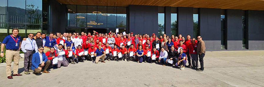 Group photo of technician graduation ceremony outside of one of our premises