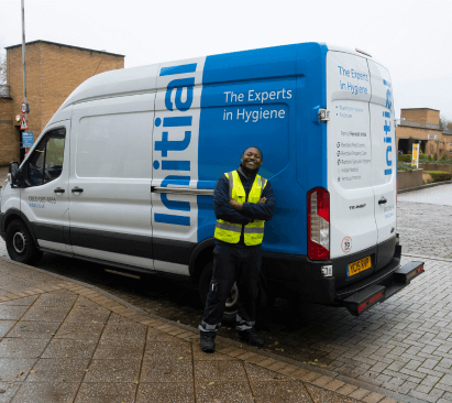 Initial Service Driver Employee Standing Next to a Van