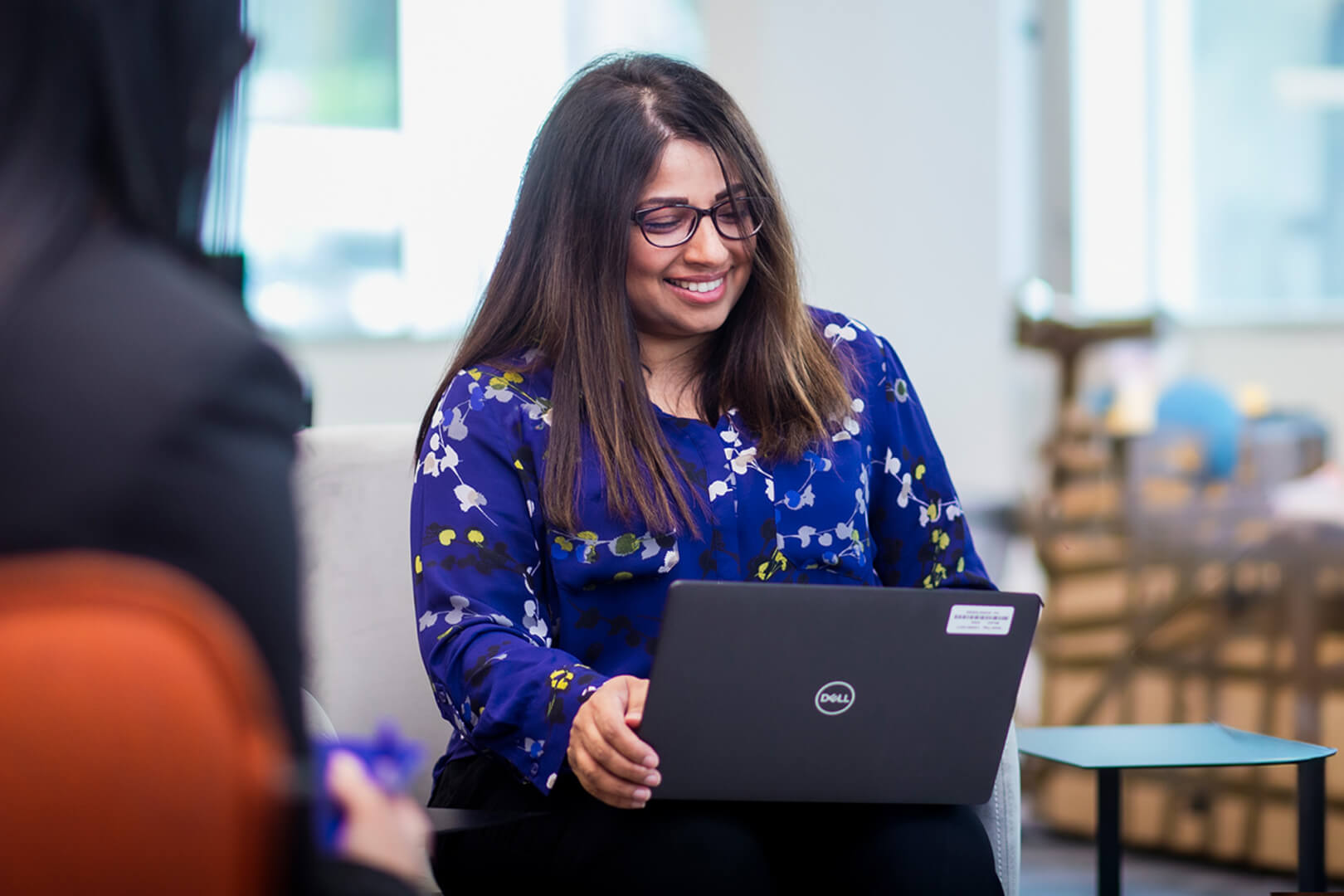 data analyst on a computer smiling 