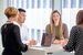 image of private markets professionals sitting around table talking in a meeting 