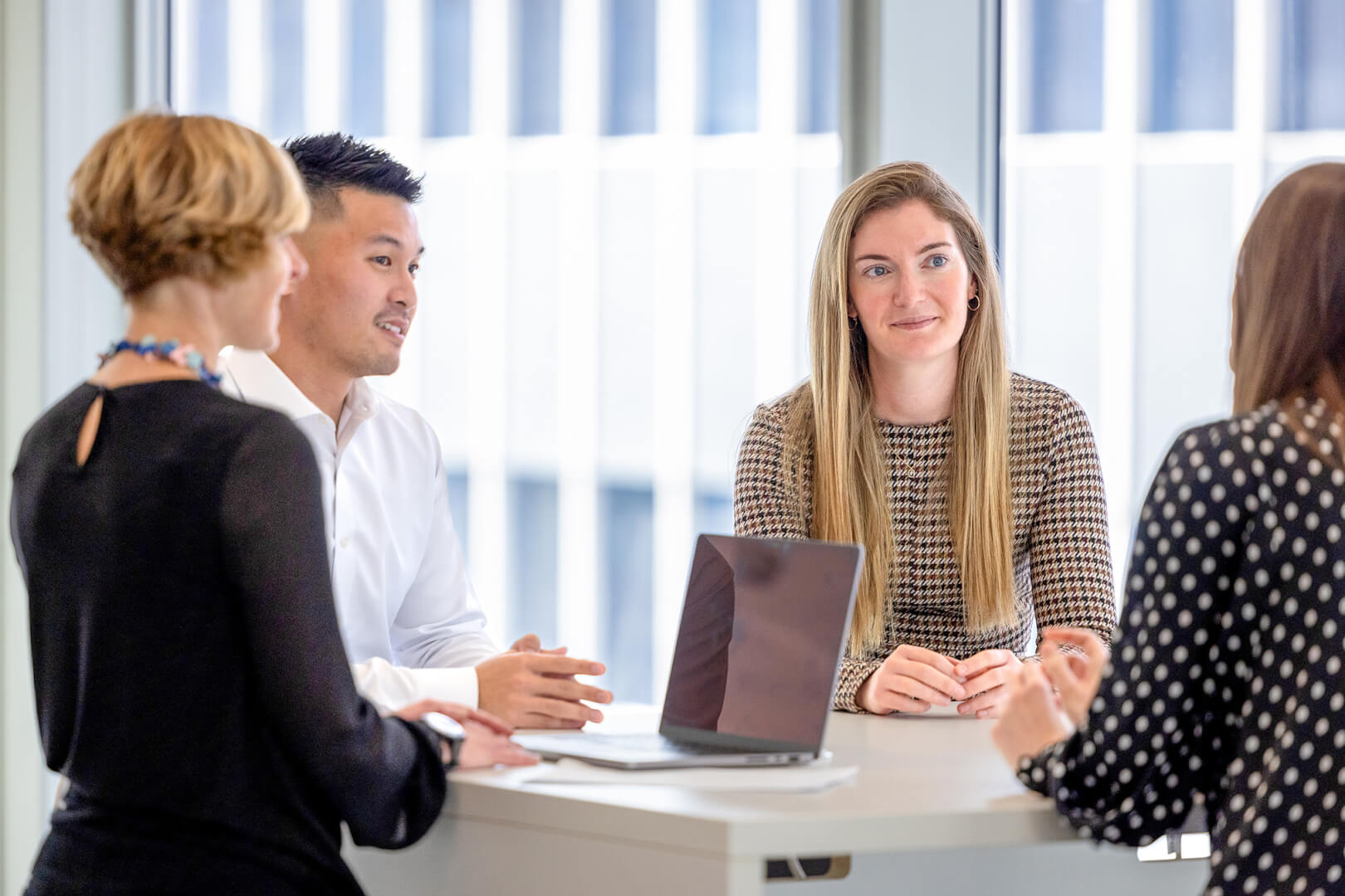 image of private markets professionals sitting around table talking in a meeting 