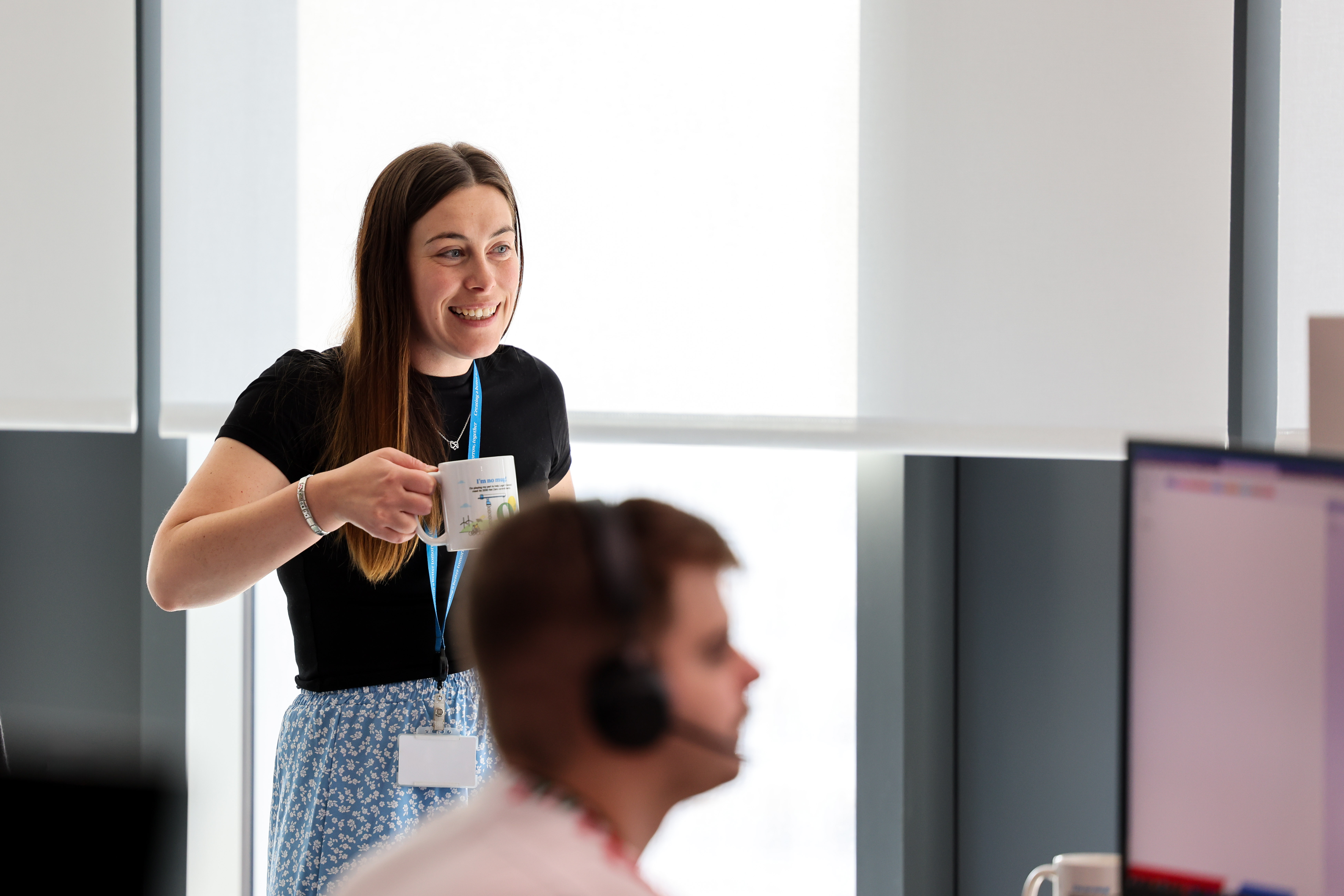 underwriter having a cup of tea and smiling 