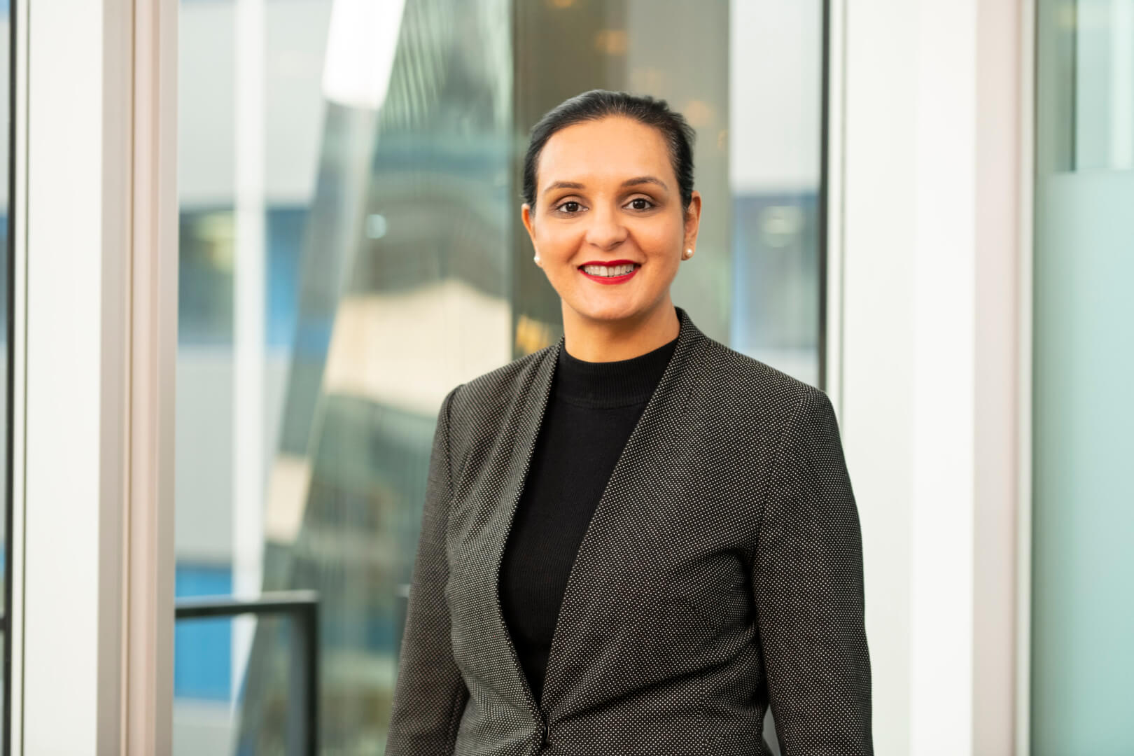 Woman in suit staring directly at the camera