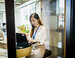 Female data engineer working on her laptop at a desk in a modern office