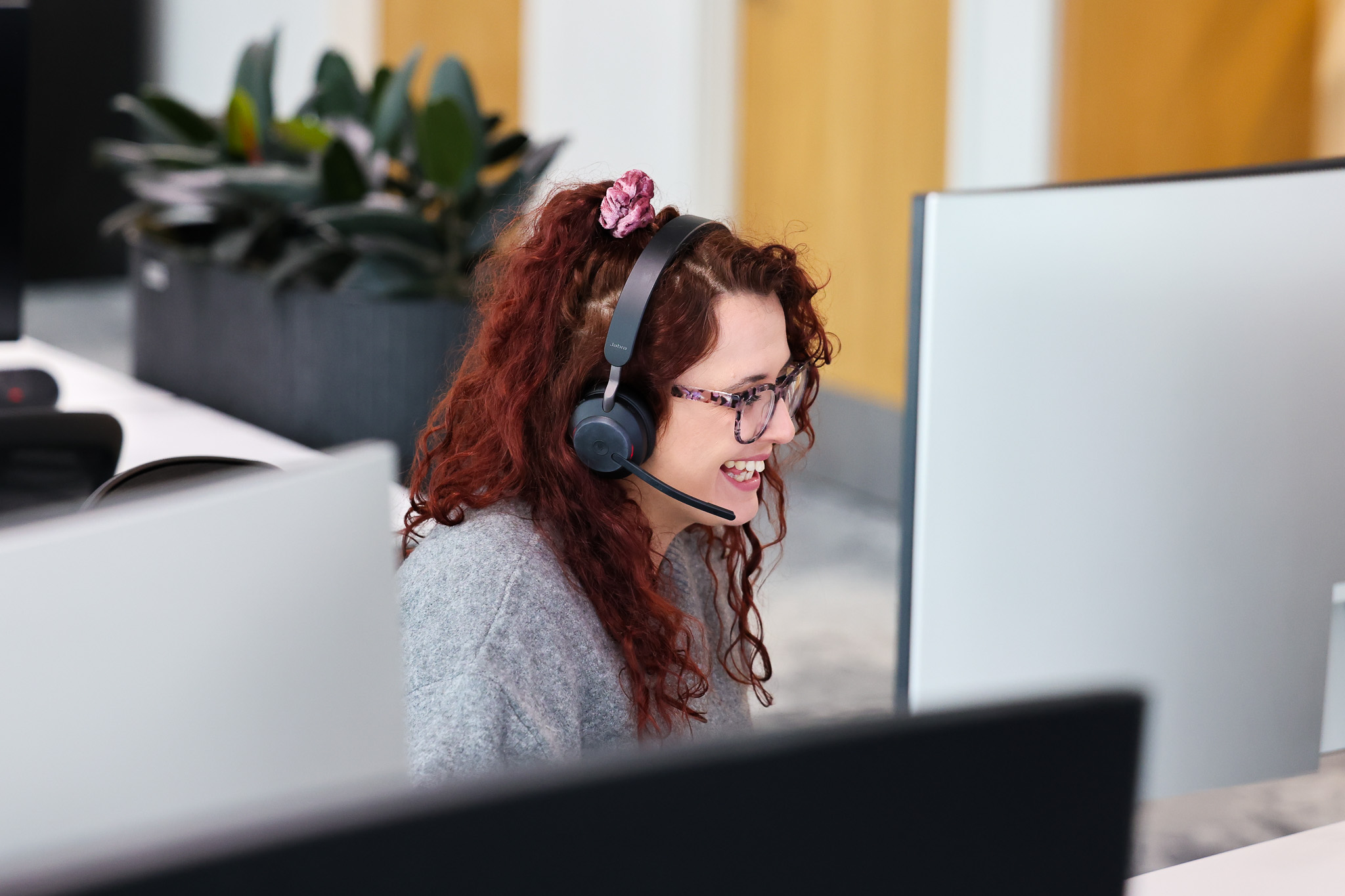 legal and general customer service rep smiling at computer