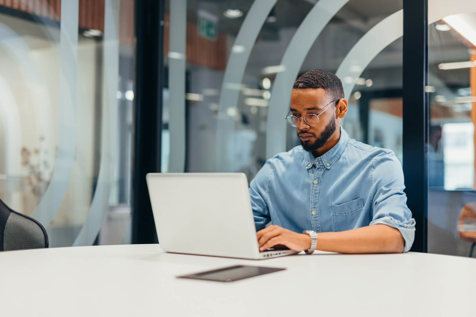 image of tech professional sitting at desk looking at their laptop