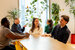 image of dublin office - colleagues sitting around a desk 