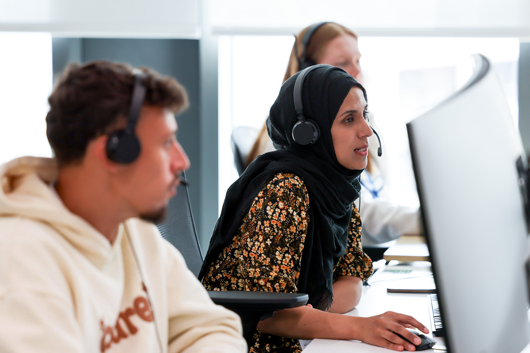 image of customer service rep on phone sitting at computer