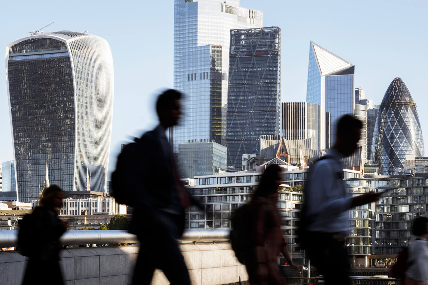 image of london skyline with people walking past 