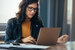 image of IT professional looking at her laptop