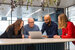 image of IT professionals surrounding a computer and smiling 