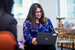 data analyst on a computer smiling 