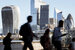 image of london skyline with people walking past 