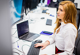 woman working on screens at desk