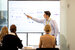 image of finance professional showcasing results to their team 