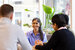 image of actuary smiling around a meeting table with other team members 