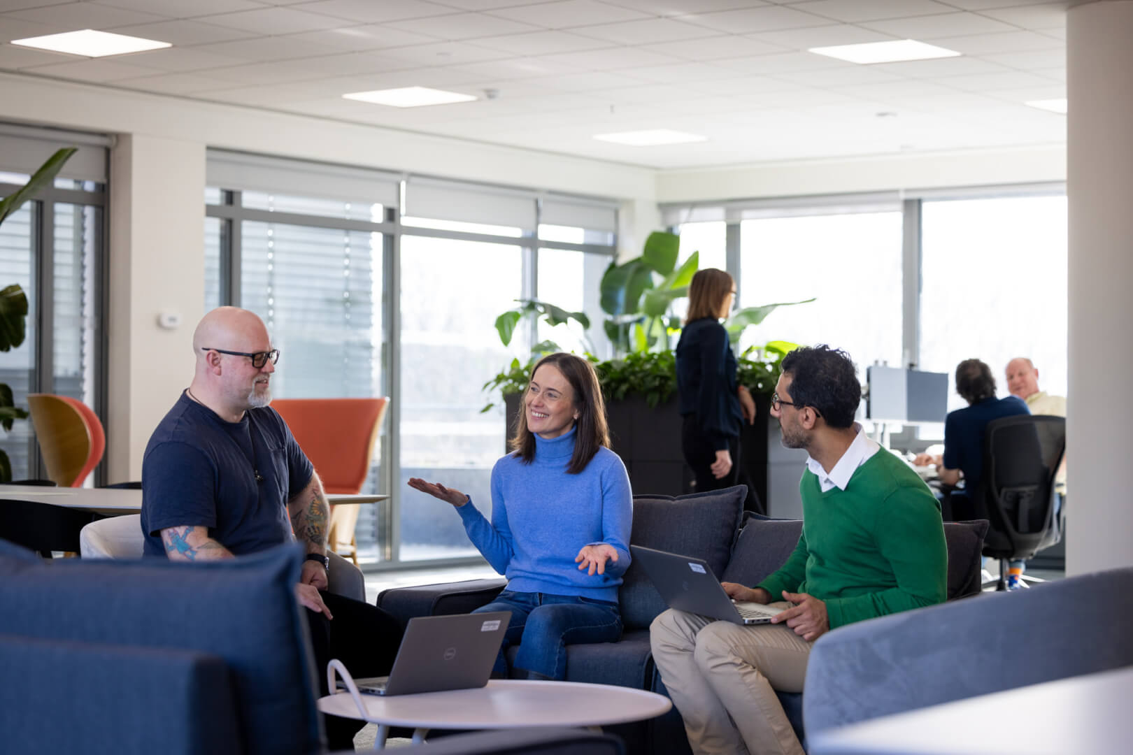 image of L&G colleagues at Brighton office sitting on sofas with laptops 