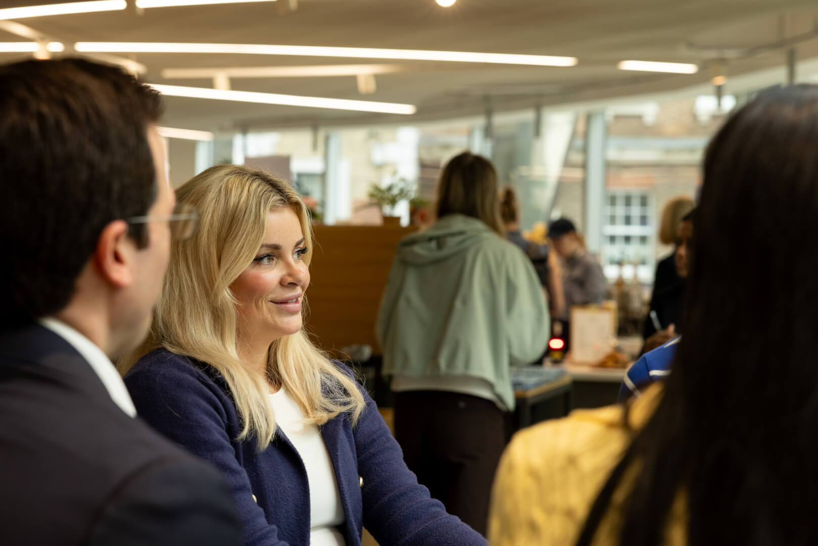image of people sitting around table for a meeting 