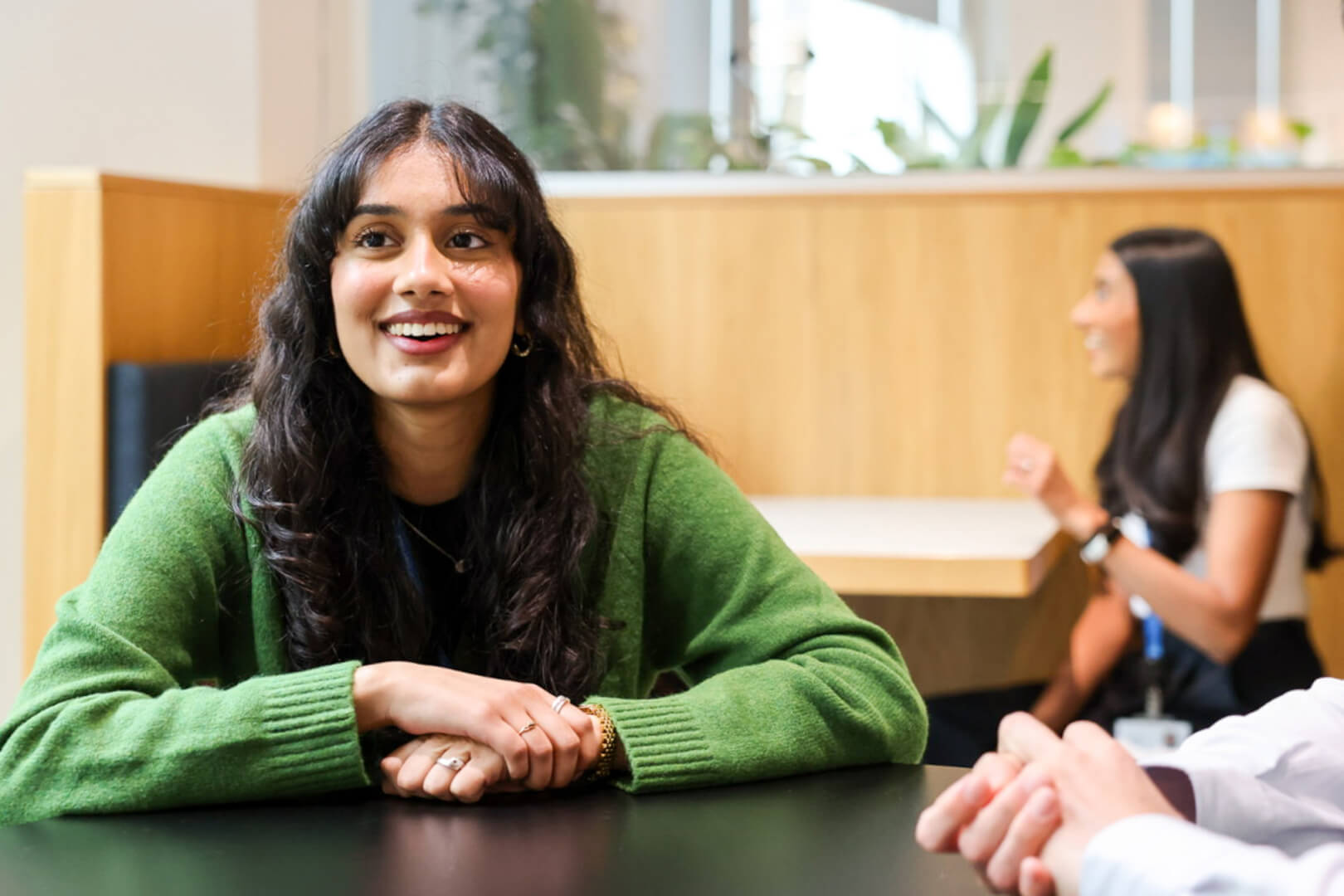 early careers professionals smiling sitting at table 