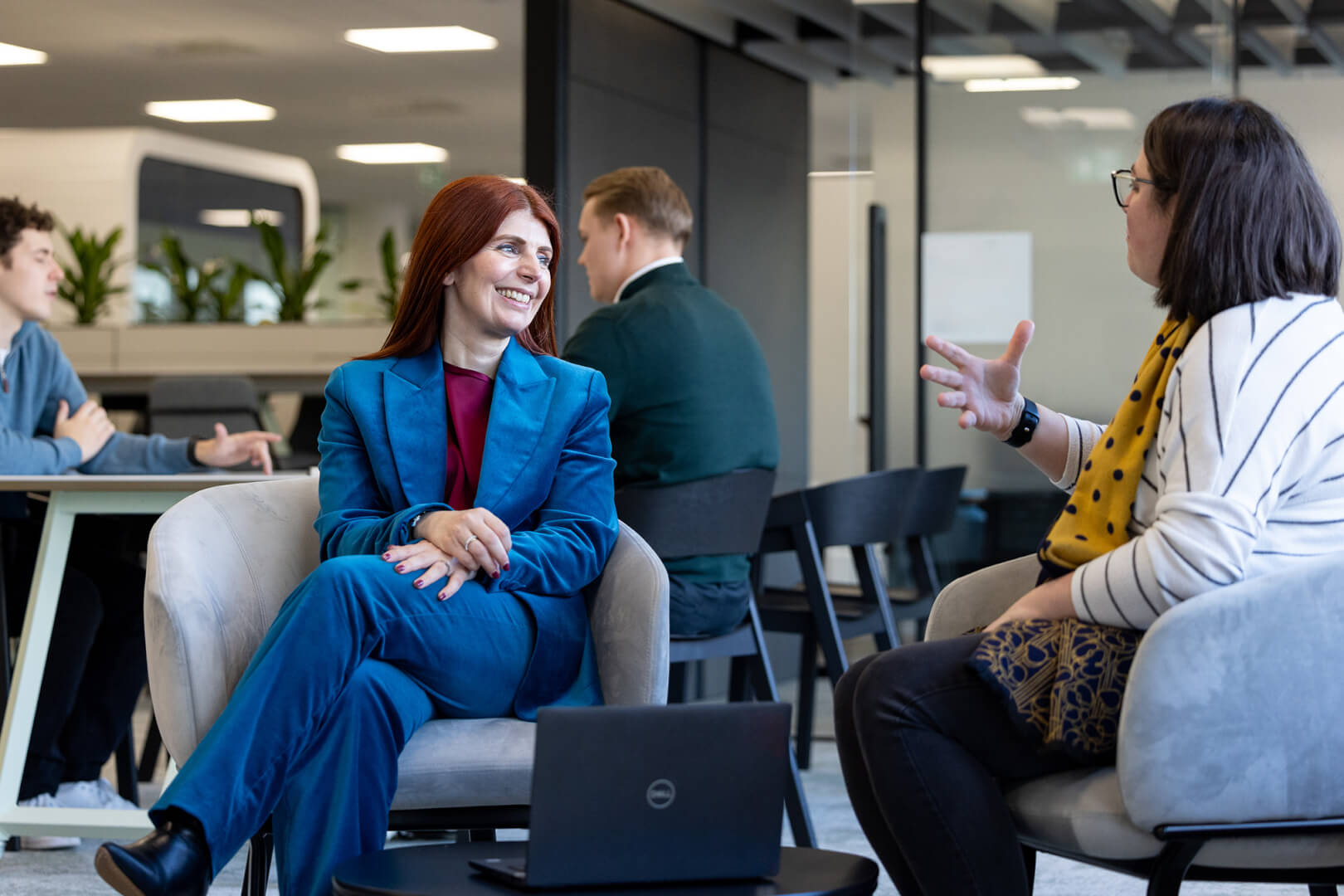 image of two colleagues sitting on sofa and talking 