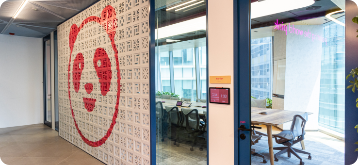 Foodpanda offices, with a large pau pau the panda logo on the wall.