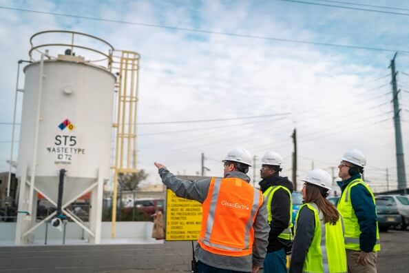 four people in high vis jackets standing on a contruction site