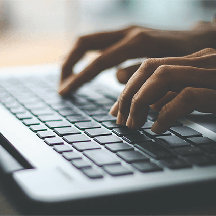 A person typing on a laptop