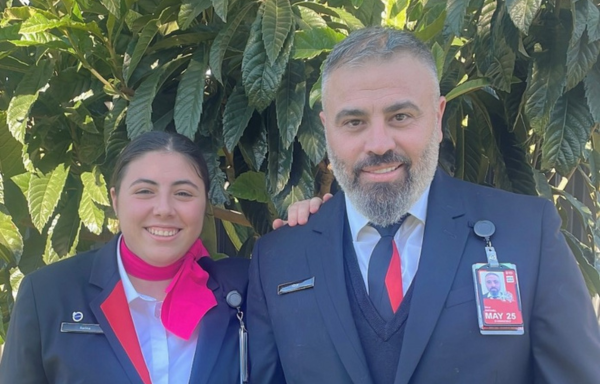 Father and daughter customer service agents smiling at camera