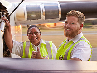 Two of our Licensed Aircraft Maintenance Engineers smiling at camera