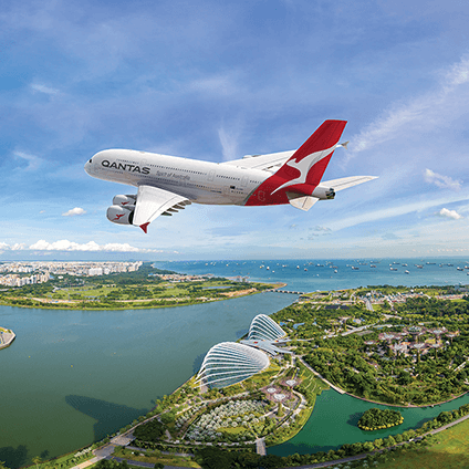 Qantas A380 aircraft flying over Singapore’s skyline