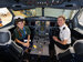 A student and pilot in the cockpit, smiling