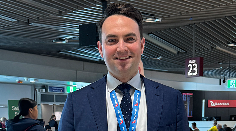 Employee at terminal, smiling at camera