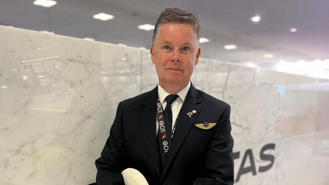 787 Captain smiling in airport terminal