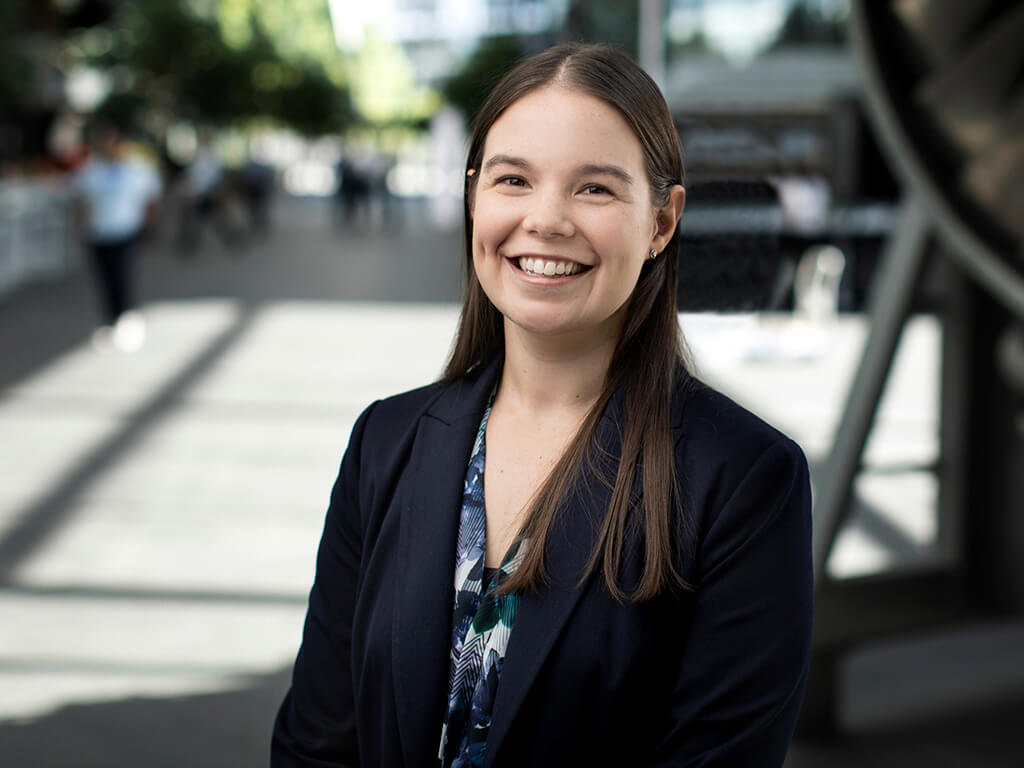 A First Nations intern at Qantas, smiling at the camera