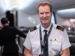 Qantas Pilot in cabin, smiling at camera