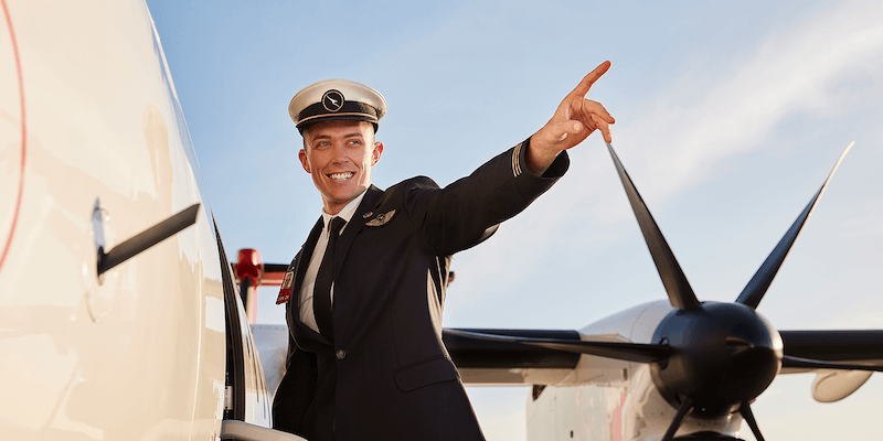 QantasLink Pilot on Airstairs, pointing out and smiling