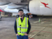 Qantas employee in the hangar, smiling at camera