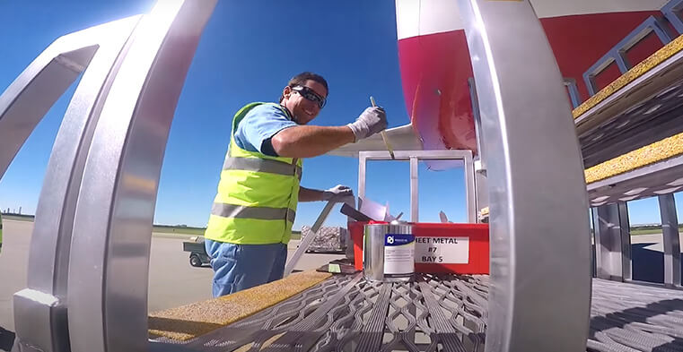 An engineer painting a plane